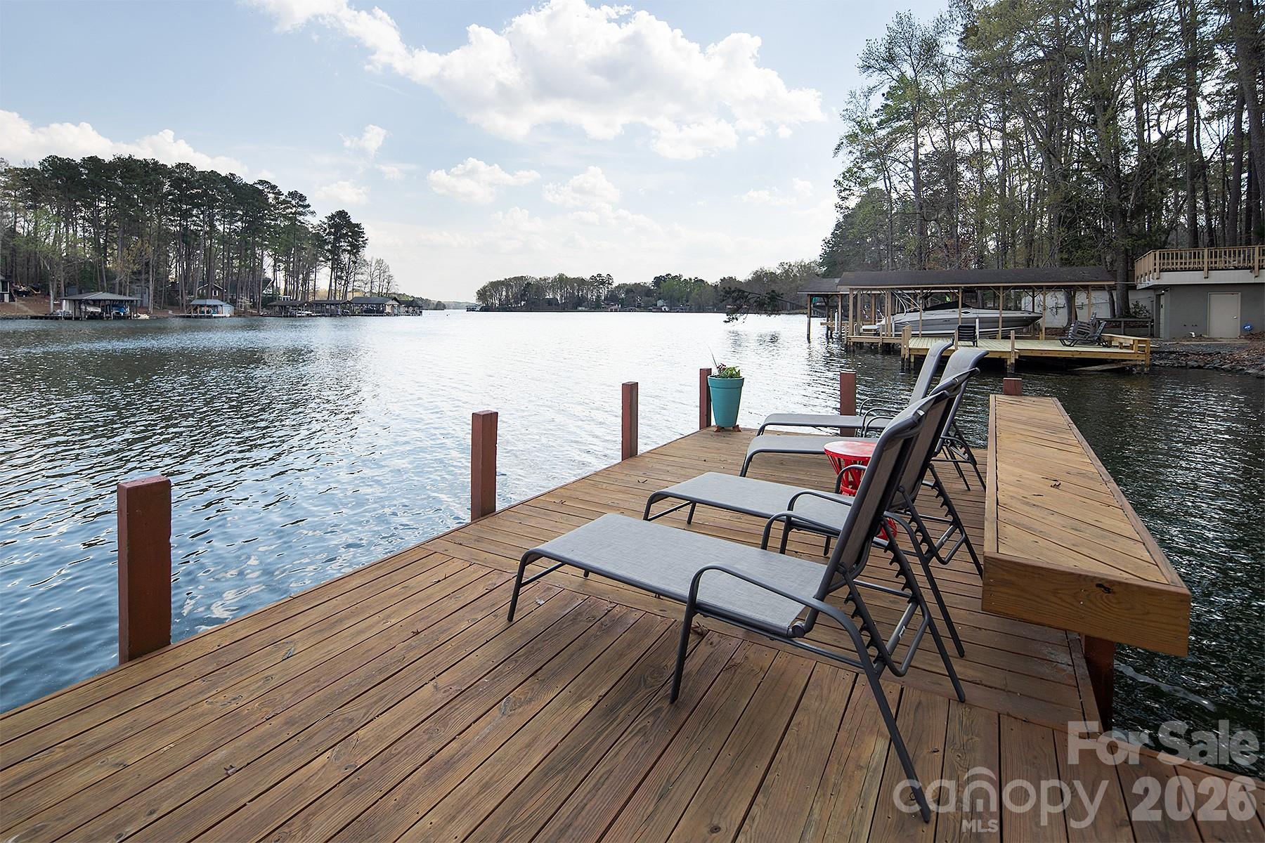 689 Emerald Shores Road Mount Gilead, NC 27306 - Photo 4 of 46 a view of a lake with table and chairs