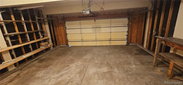 a view of an empty room with wooden staircase