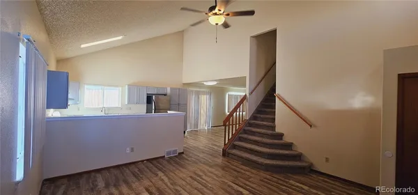 a room with stairs and wooden floor