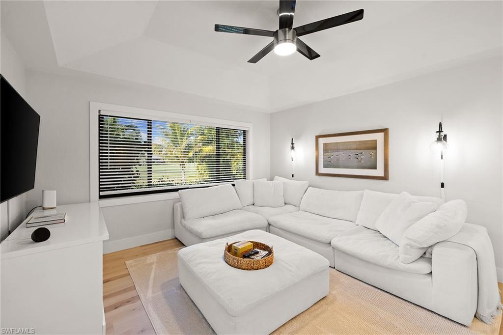 130 Torrey Pines Point Naples, FL 34113 - Photo 13 of 44 a living room with furniture and a flat screen tv