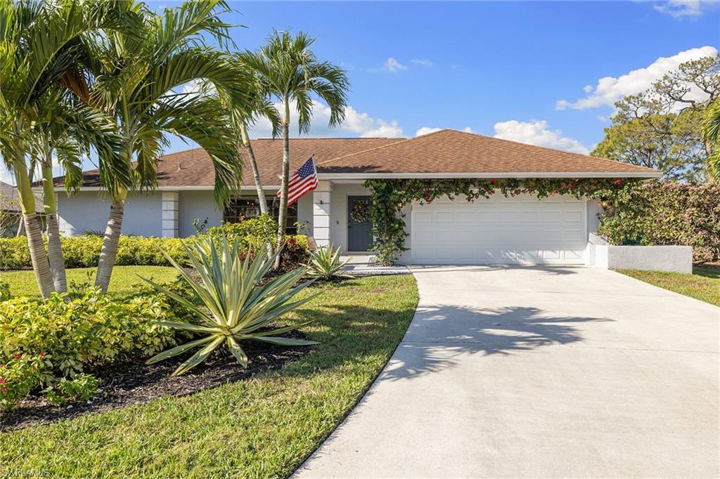 130 Torrey Pines Point Naples, FL 34113 - Photo 2 of 44 a front view of a house with garden