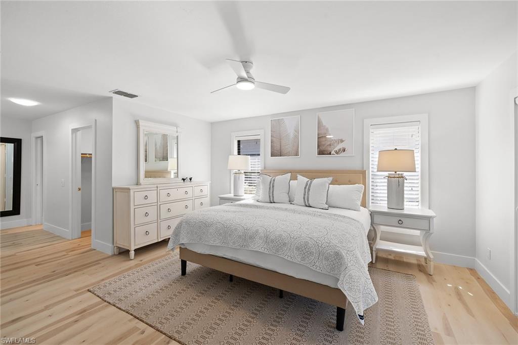 130 Torrey Pines Point Naples, FL 34113 - Photo 21 of 44 a spacious bedroom with a bed and cabinet