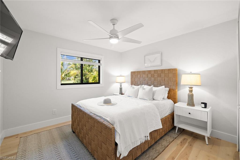 130 Torrey Pines Point Naples, FL 34113 - Photo 26 of 44 a bedroom with a bed and a chandelier