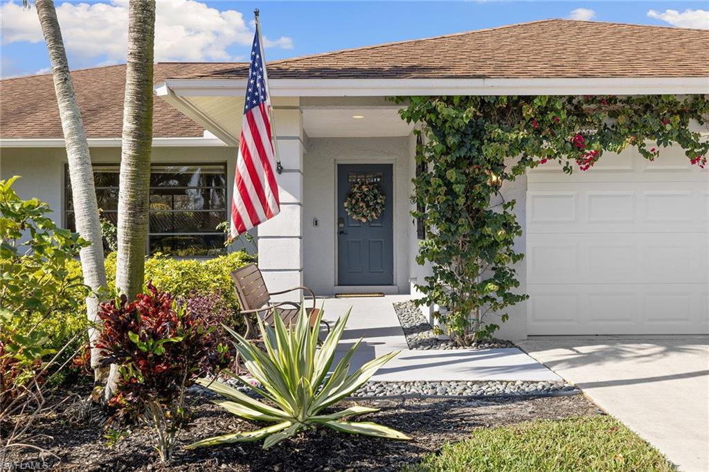 130 Torrey Pines Point Naples, FL 34113 - Photo 3 of 44 a front view of a house with garden