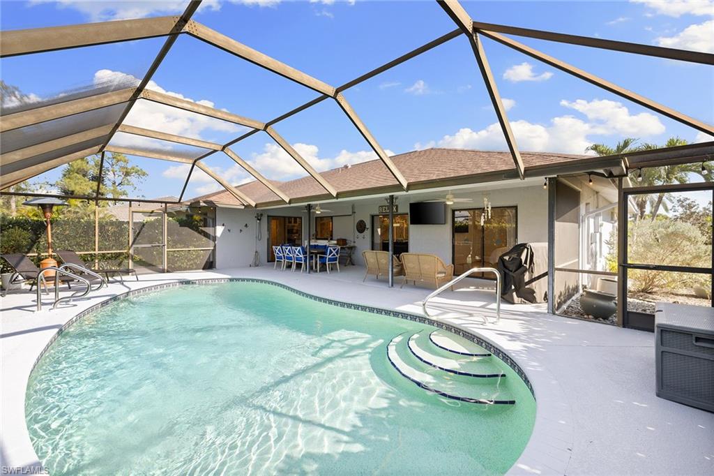 130 Torrey Pines Point Naples, FL 34113 - Photo 32 of 44 a view of a swimming pool with a patio