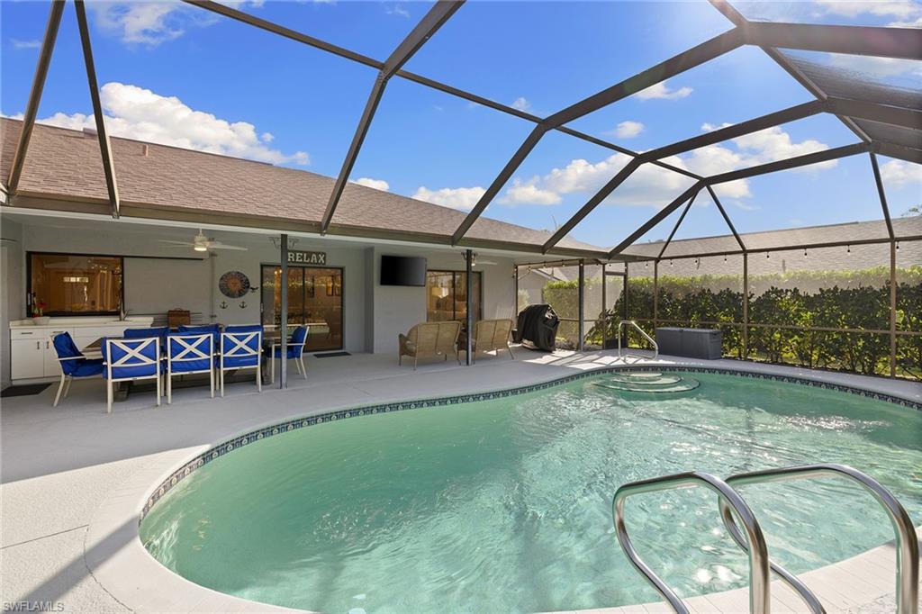 130 Torrey Pines Point Naples, FL 34113 - Photo 34 of 44 a view of a swimming pool with outdoor seating