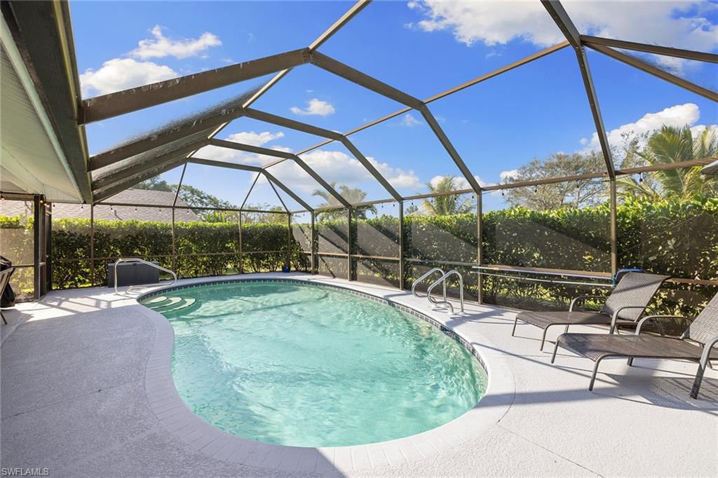 130 Torrey Pines Point Naples, FL 34113 - Photo 36 of 44 a view of a swimming pool with a patio