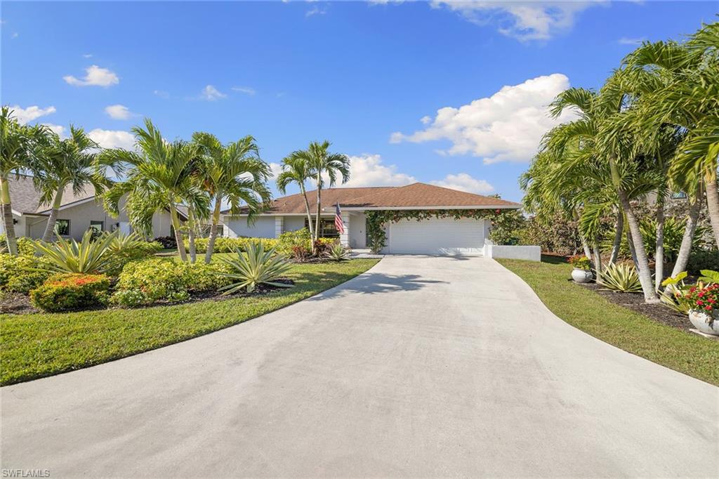 130 Torrey Pines Point Naples, FL 34113 - Photo 40 of 44 a view of a house with a yard and potted plants