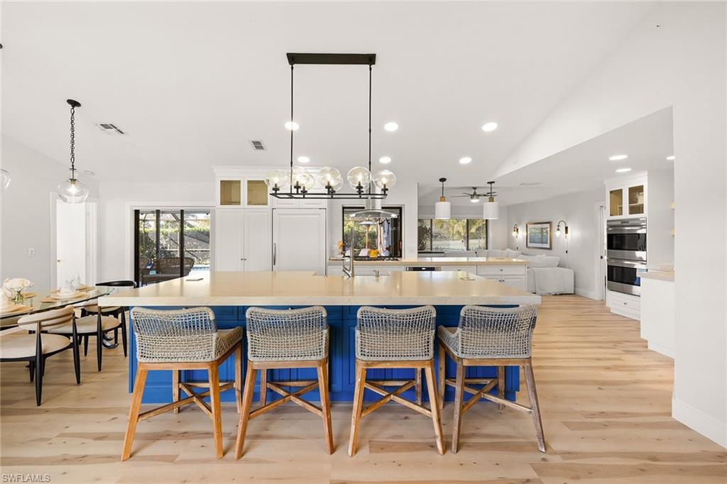 130 Torrey Pines Point Naples, FL 34113 - Photo 5 of 44 a dining hall with stainless steel appliances kitchen island granite countertop a dining table chairs and view living room