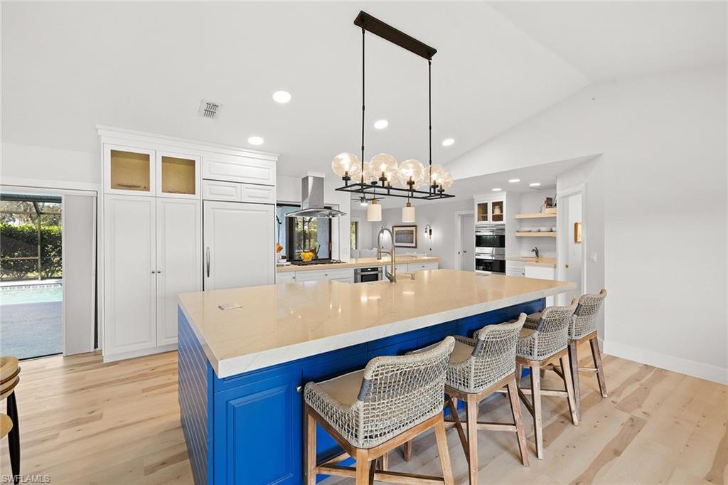 130 Torrey Pines Point Naples, FL 34113 - Photo 6 of 44 a large kitchen with a table and chairs