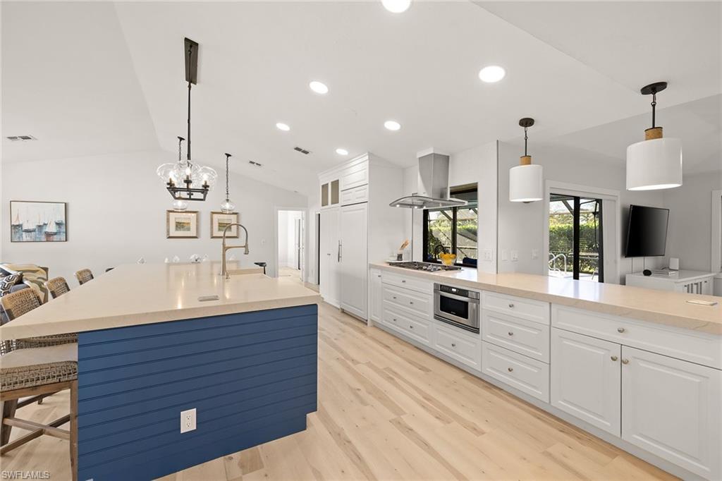 130 Torrey Pines Point Naples, FL 34113 - Photo 8 of 44 a large kitchen with kitchen island a sink stainless steel appliances and cabinets
