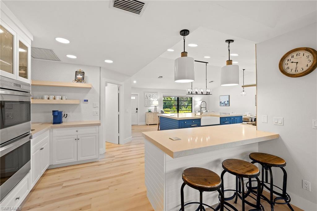 130 Torrey Pines Point Naples, FL 34113 - Photo 10 of 44 a large kitchen with a table and chairs