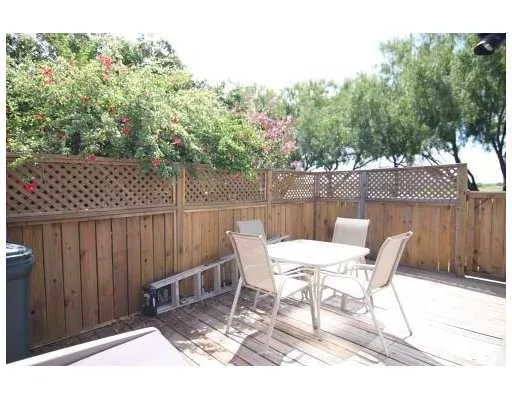 a view of a chairs and table in the patio