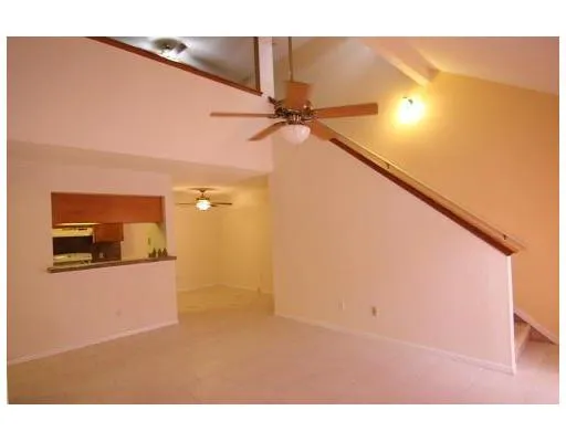 a picture of a room with a ceiling fan