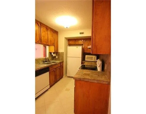 a kitchen with a sink cabinets and a window