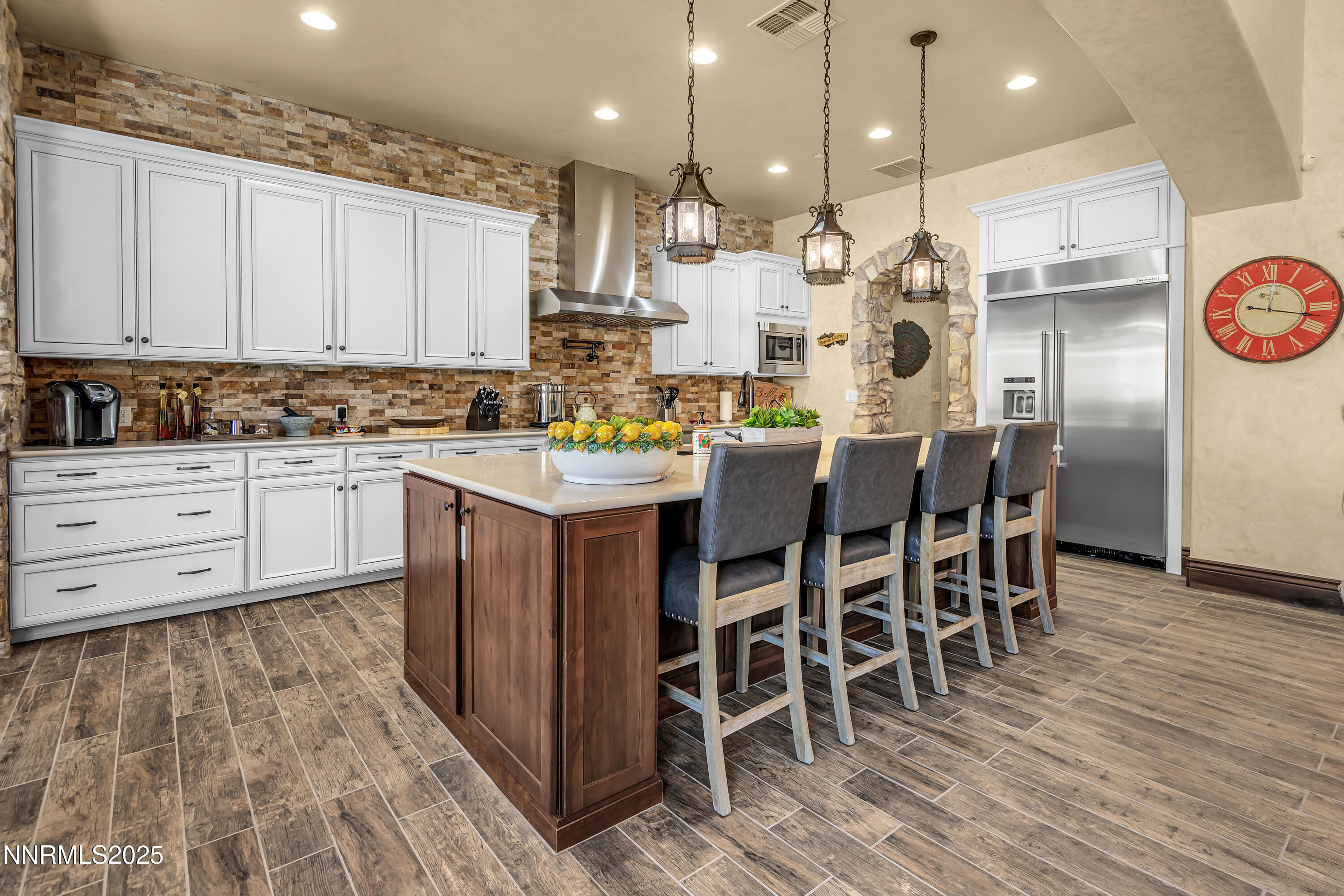 3166 Vista Favoloso Reno, NV 89519 - Photo 11 of 81 a kitchen with stainless steel appliances kitchen island granite countertop a table chairs sink and cabinets