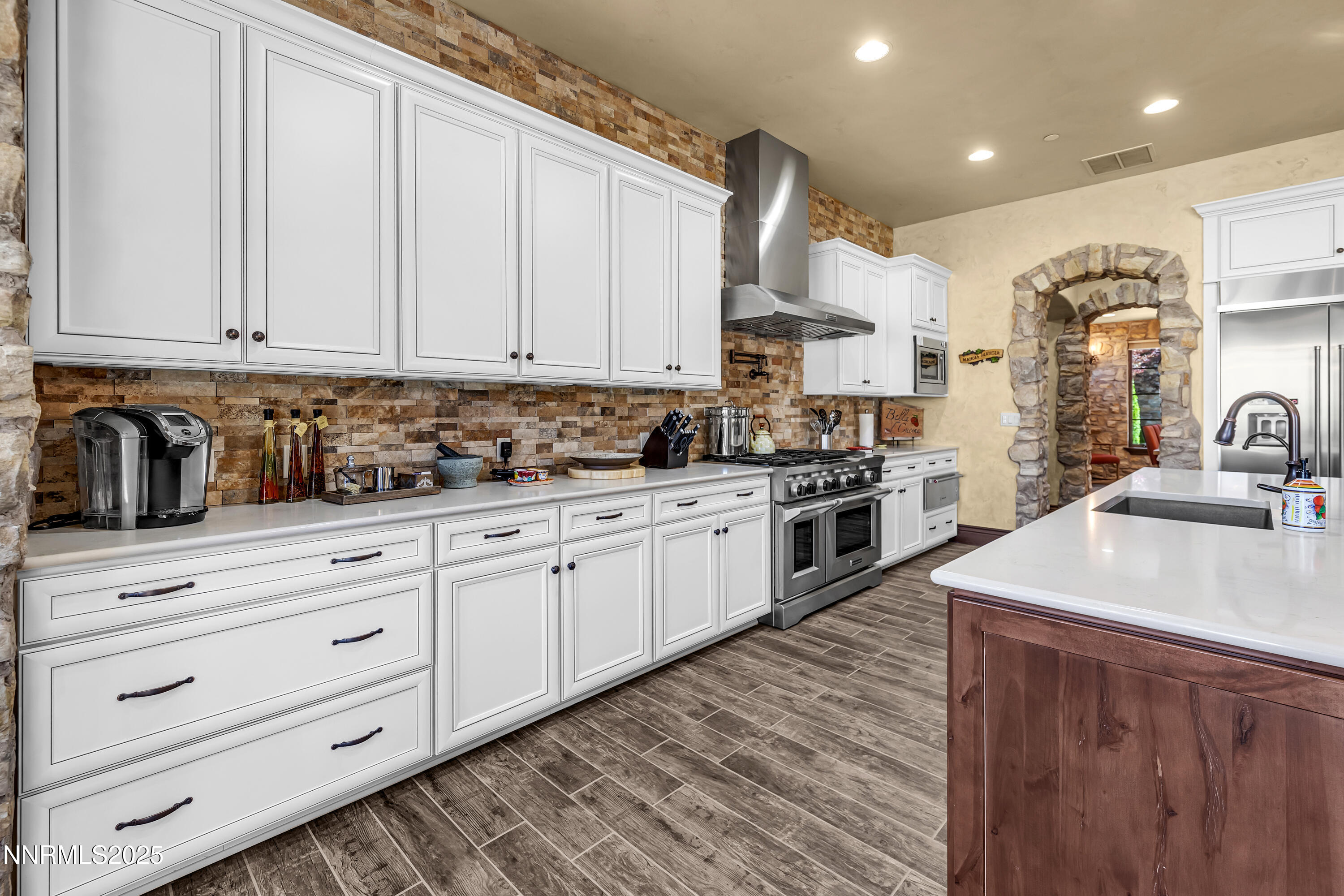3166 Vista Favoloso Reno, NV 89519 - Photo 15 of 81 a kitchen with stainless steel appliances granite countertop a sink a stove and cabinets