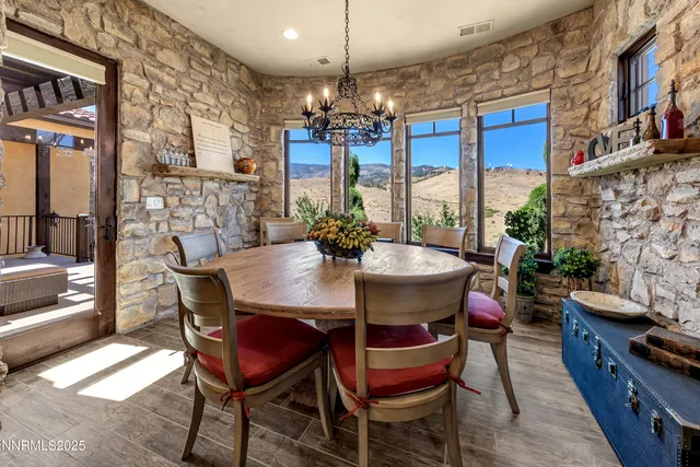 a view of a dining room with furniture a chandelier and wooden floor