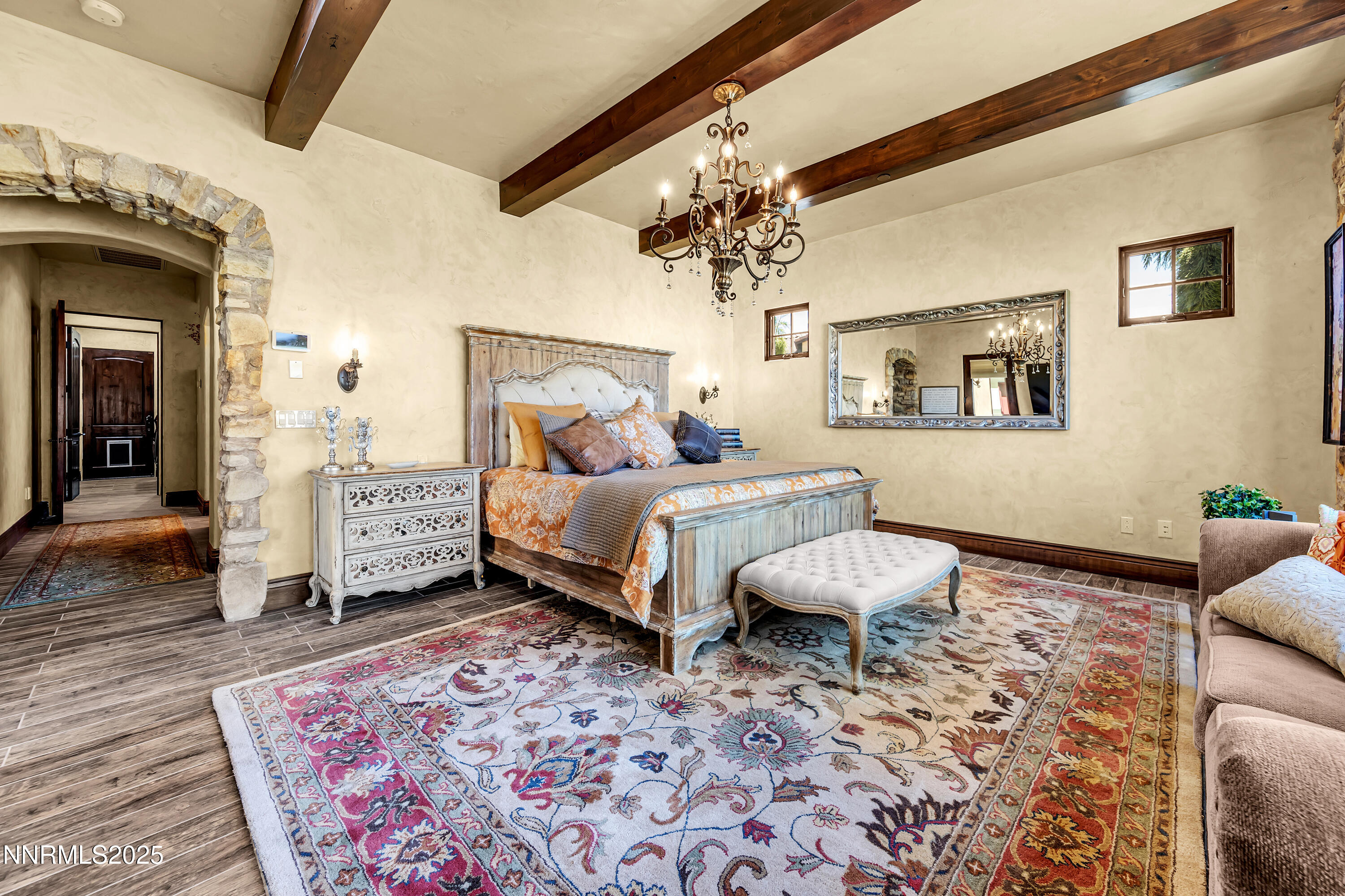 3166 Vista Favoloso Reno, NV 89519 - Photo 25 of 81 a spacious bedroom with a bed a chandelier and a rug