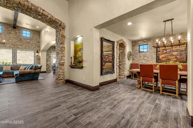 a living room with furniture kitchen view and a large window