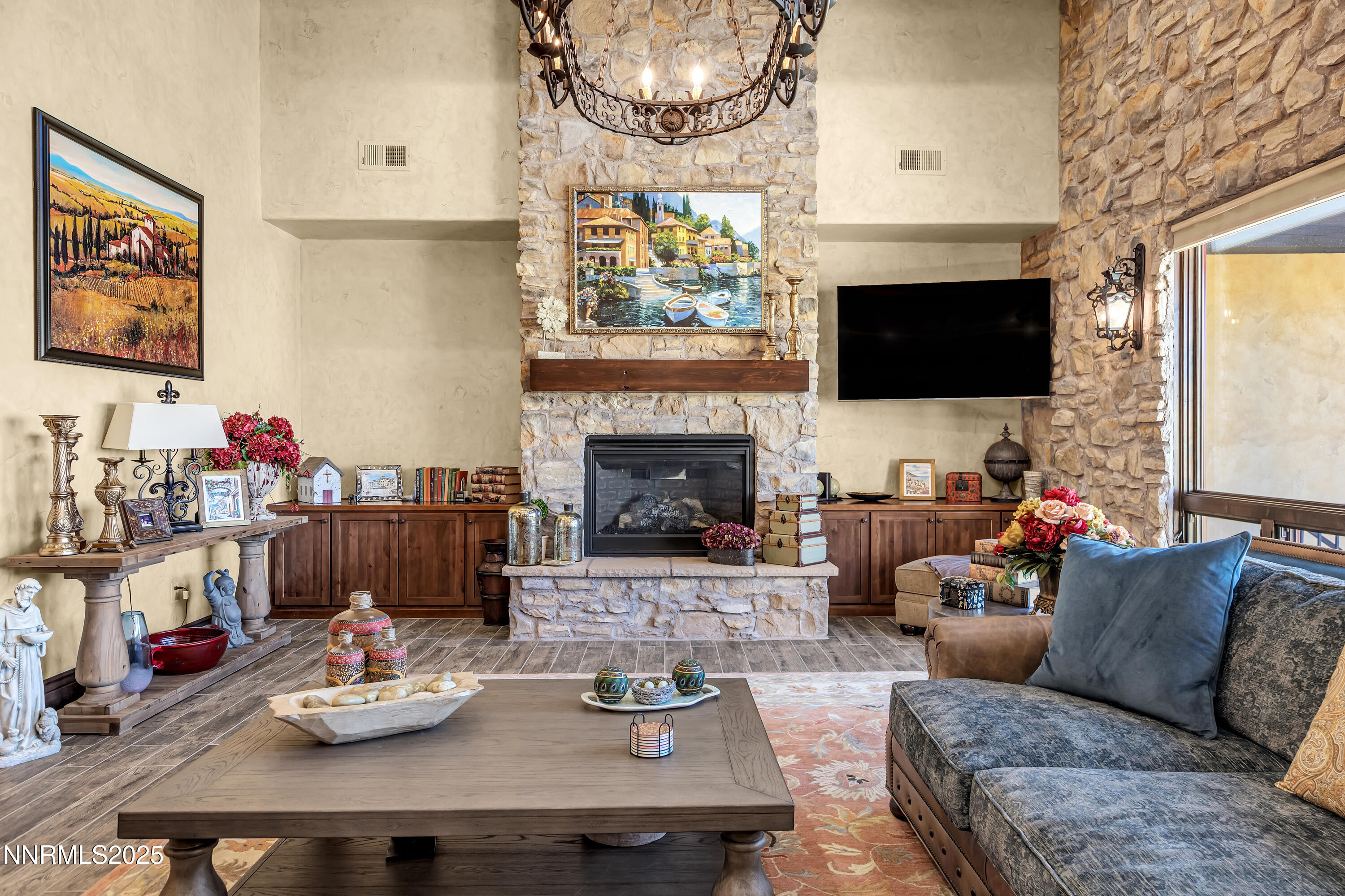 3166 Vista Favoloso Reno, NV 89519 - Photo 9 of 81 a living room with furniture a flat screen tv and a fireplace