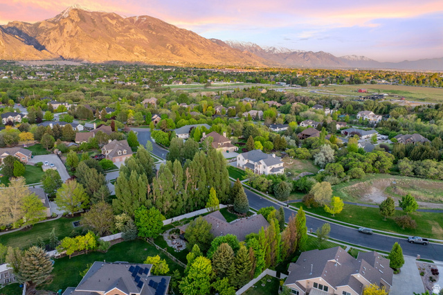 6208 West Bull River Road Highland, UT 84003 - Photo 85 of 90 Expansive residential area featuring a mountain backdrop, mature trees, and paved roads