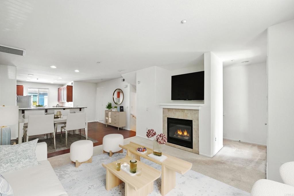 1569 Hackberry Place Chula Vista, CA 91915 - Photo 1 of 23 a living room with furniture a flat screen tv and a fireplace