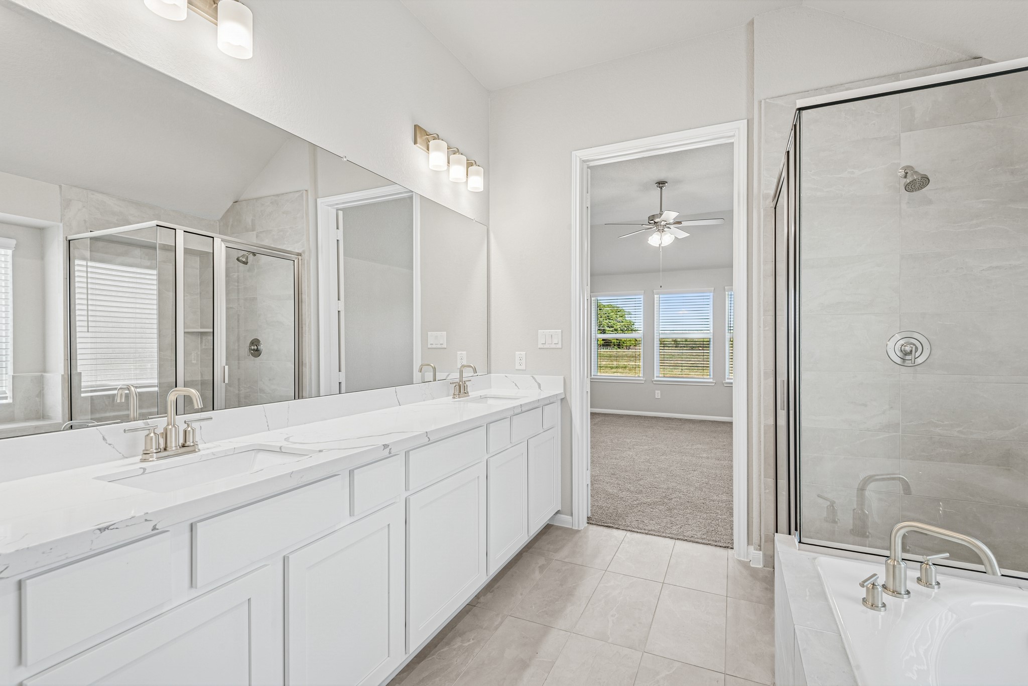 6715 Allens Landing Needville, TX 77461 - Photo 12 of 40 a bathroom with a double vanity sink mirror and shower