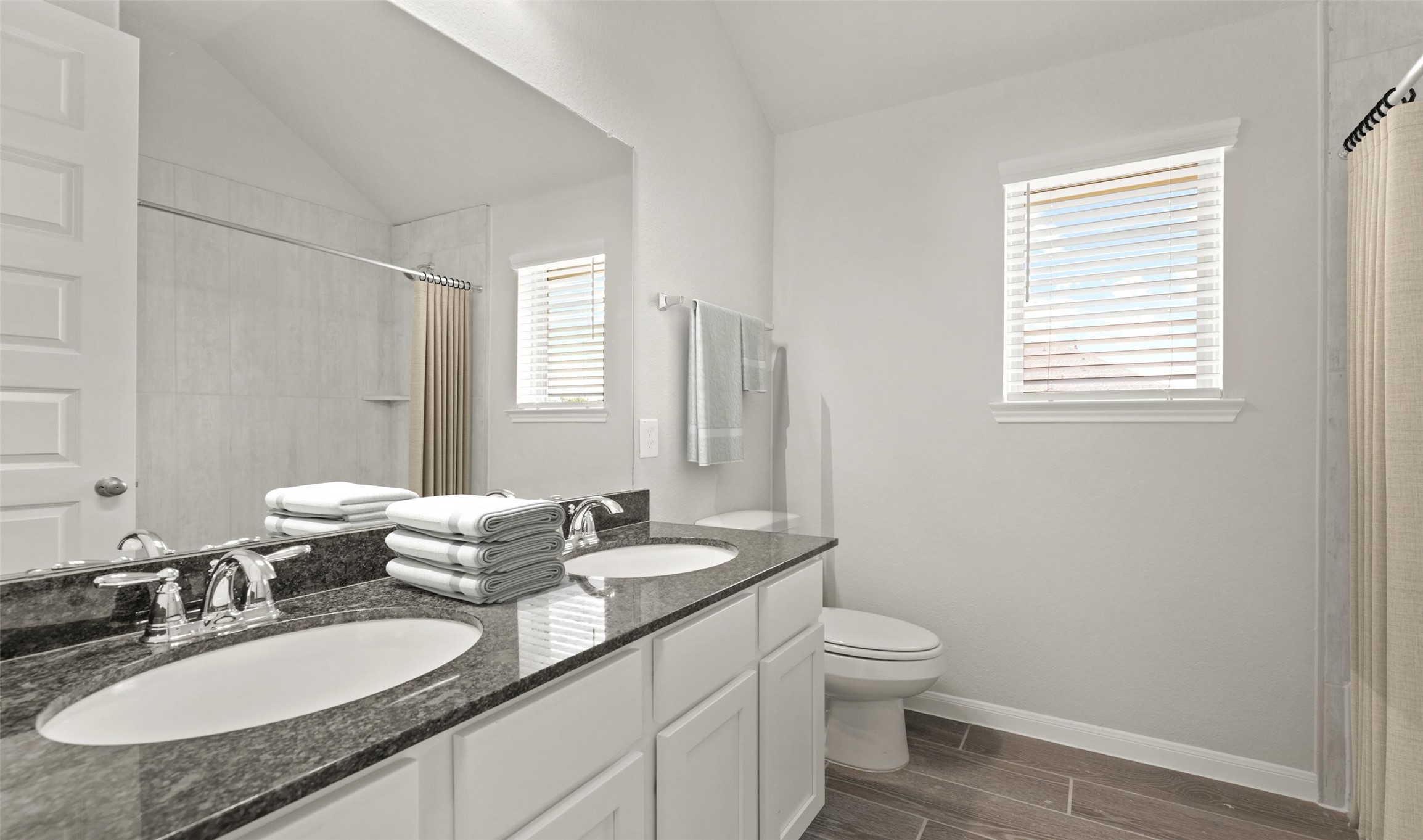 6715 Allens Landing Needville, TX 77461 - Photo 36 of 40 a bathroom with a granite countertop sink toilet a large mirror and shower