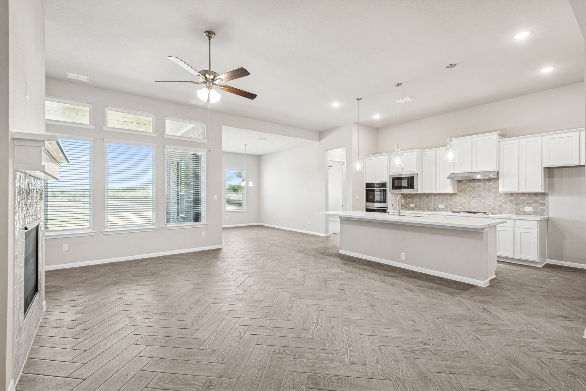 6715 Allens Landing Needville, TX 77461 - Photo 6 of 40 a large kitchen with granite countertop a large counter top a sink stainless steel appliances and cabinets