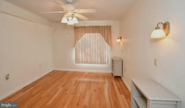 a view of a livingroom with wooden floor and a flat screen tv