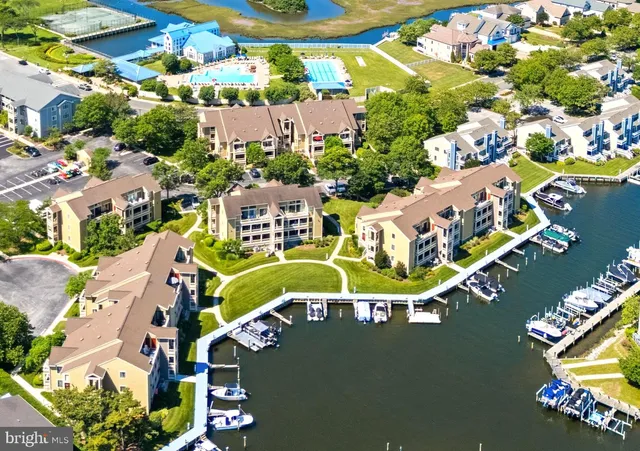 an aerial view of a house with a swimming pool outdoor seating
