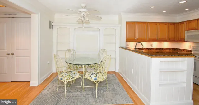 a kitchen with stainless steel appliances granite countertop a sink and a refrigerator