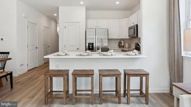 a kitchen with a sink appliances and cabinets