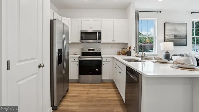 a kitchen with a sink stove and microwave