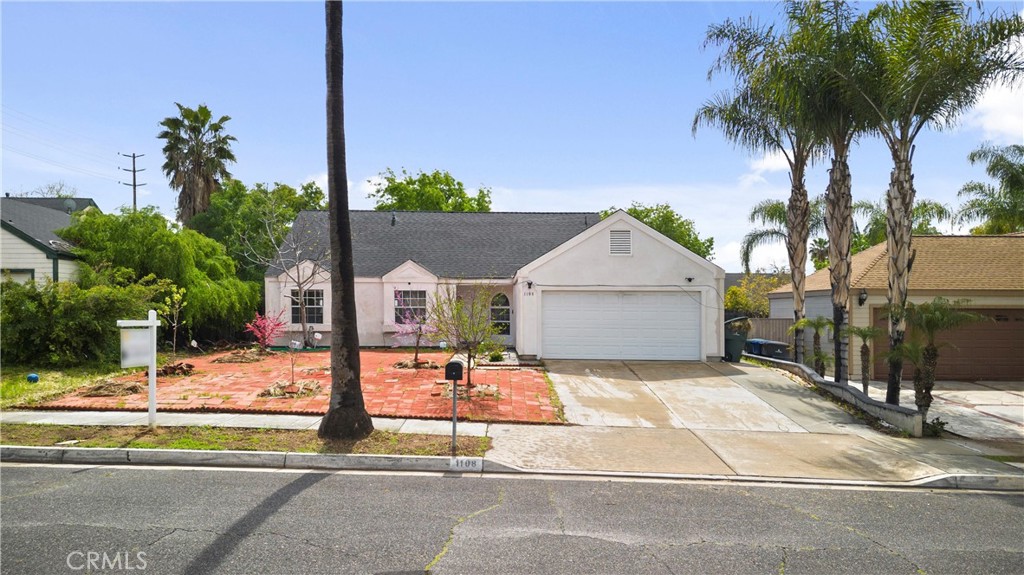 1108 Massachusetts Avenue Riverside, CA 92507 - Photo 1 of 1 a view of a house with a yard and palm trees