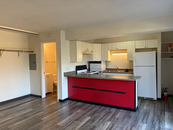 a kitchen with sink refrigerator and window
