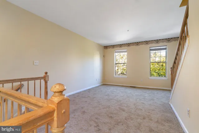 a view of an empty room with windows