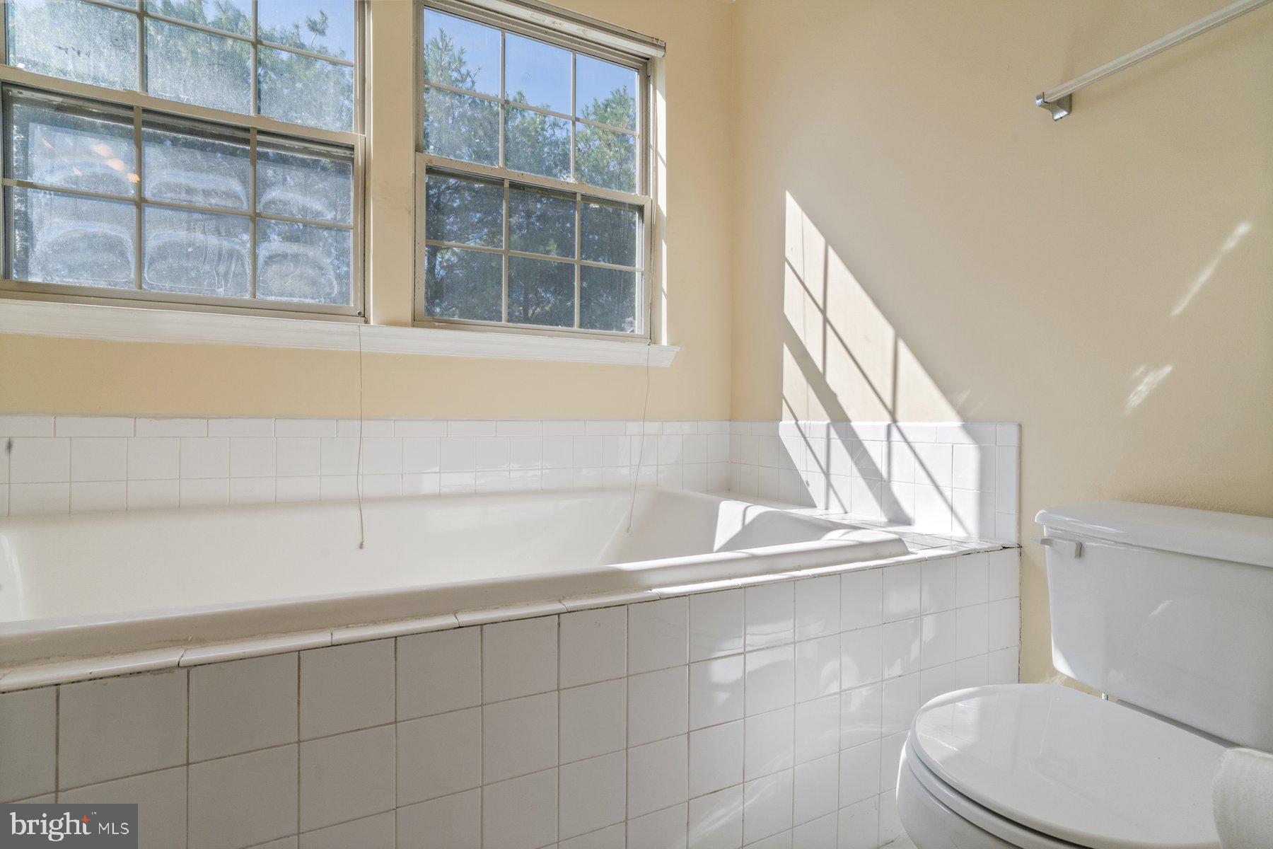 11 Bank Spring Court Owings Mills, MD 21117 - Photo 18 of 35 a bathroom with a toilet a sink and a bathtub