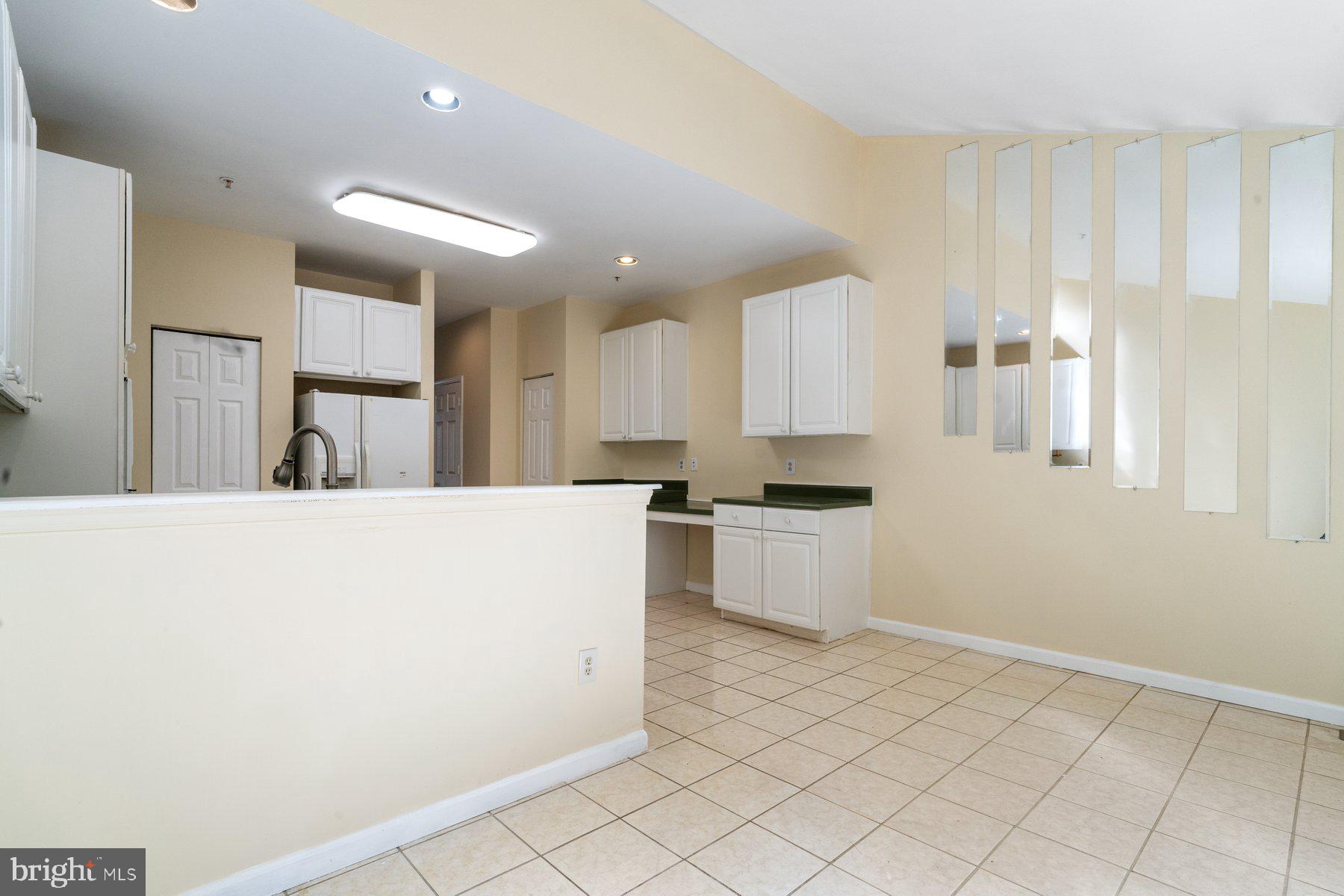 11 Bank Spring Court Owings Mills, MD 21117 - Photo 8 of 35 a large white kitchen with a sink and cabinets