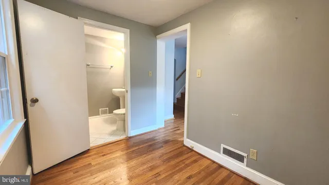 a view of a room with wooden floor