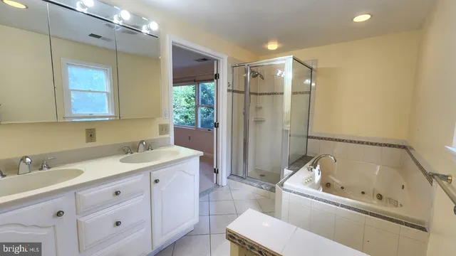 a bathroom with a tub sink and mirror