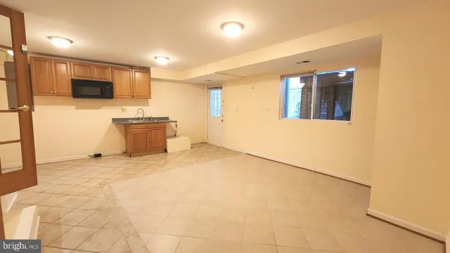 a view of an empty room with wooden floor and entryway