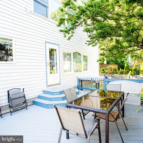 a view of a patio with couches chairs and a fire pit