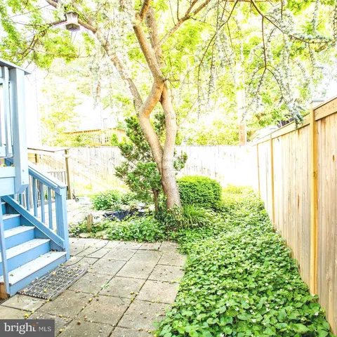 a view of a pathway with a garden