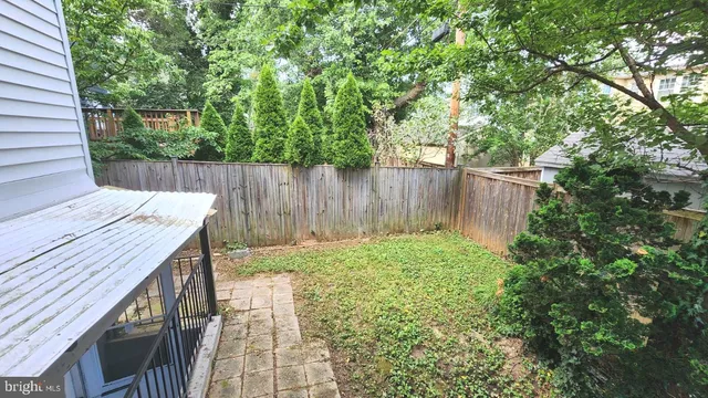 a view of a house with a yard and potted plants