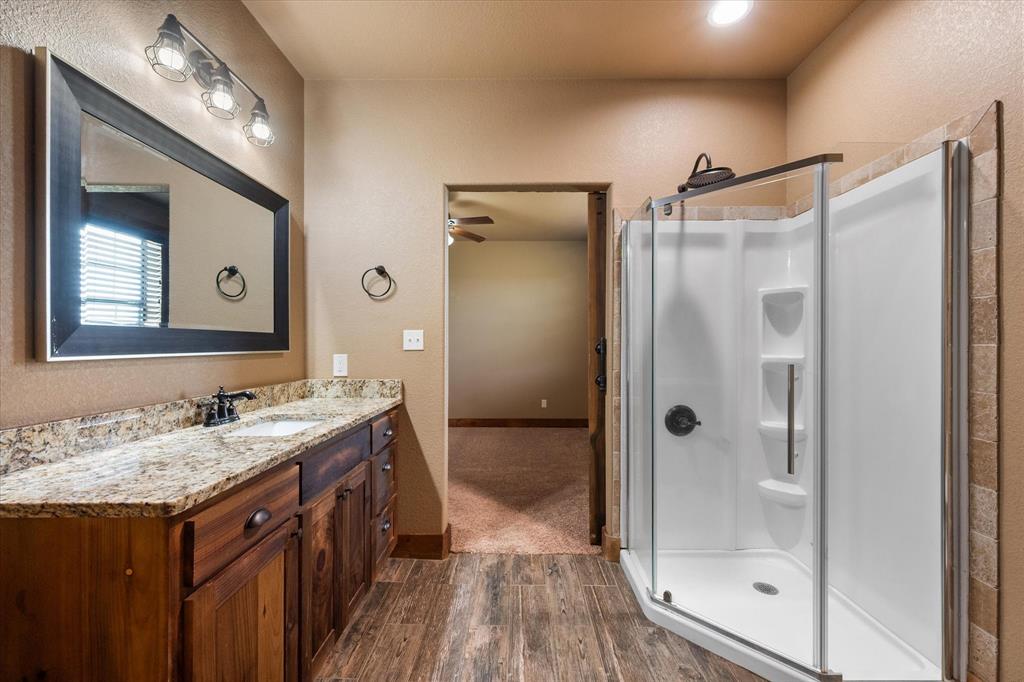 845 North Cardinal Road Azle, TX 76020 - Photo 13 of 37 a bathroom with a granite countertop sink mirror shower and vanity