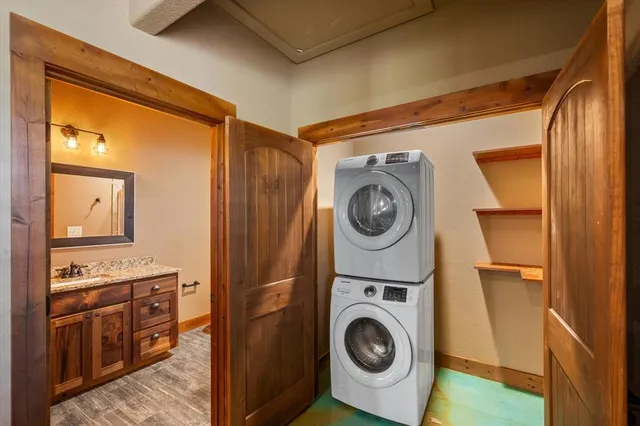 a utility room with sink dryer and washer