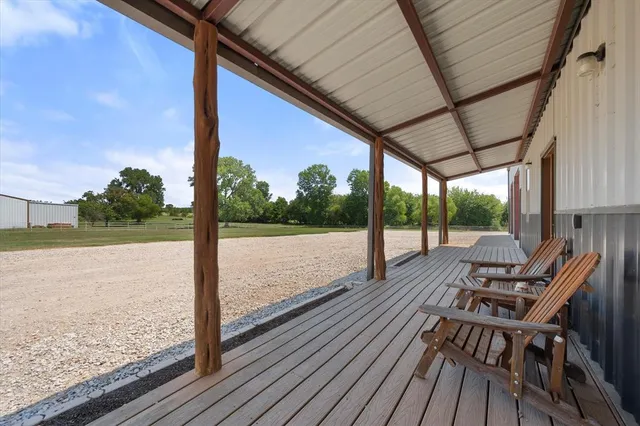 a view of balcony with wooden floor and fence