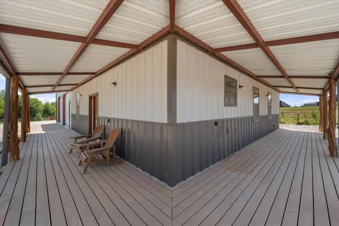 a view of a wooden deck with furniture